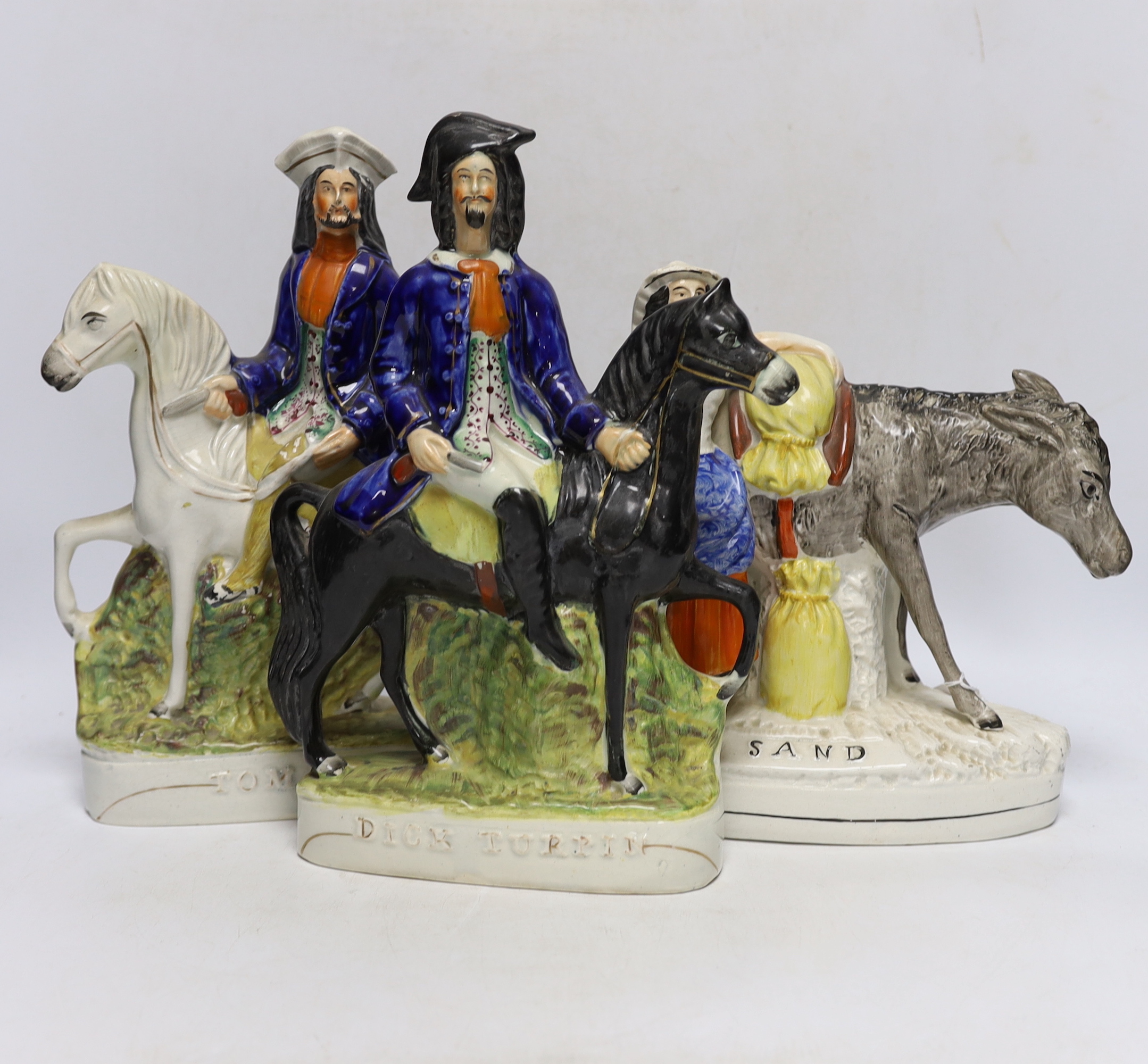 Three mid 19th century Staffordshire figure groups including Dick Turpin, Tom King and Sand, tallest 30cm